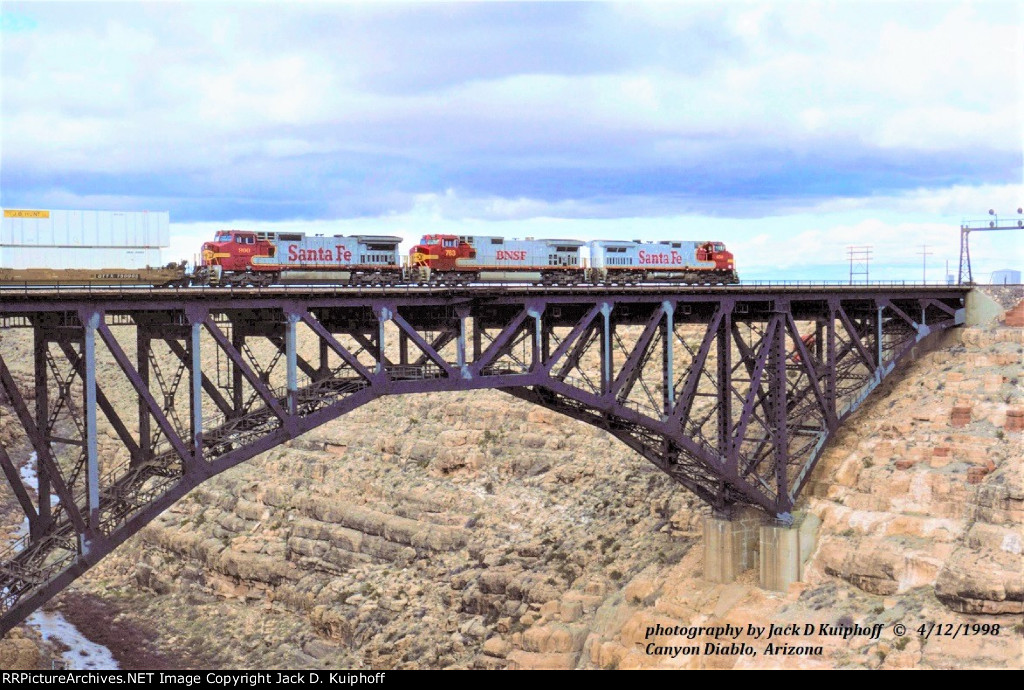 AT&SF, Santa Fe, C44-9W 650 - 763 -C40-8W 900 with an eastbound stack train crossing the steel arched bridge at Canyon Diablo, Arizona. April 12, 1998.